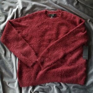 Fuzzy maroon sweater.
